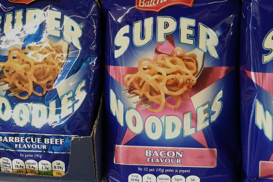 Packages of instant Super Noodles on a store shelf