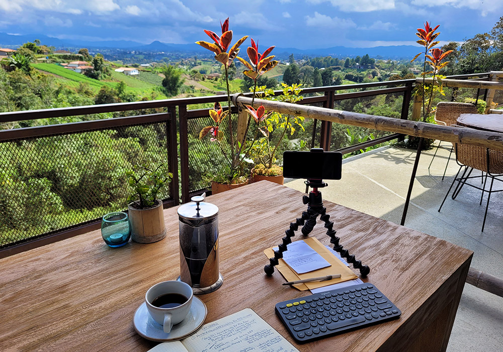 Remote working setup at Cannua Ecolodge with Logitech K380 keyboard, a Joby tripod, a DuoTurbo WIFI hotspot keeping me connected