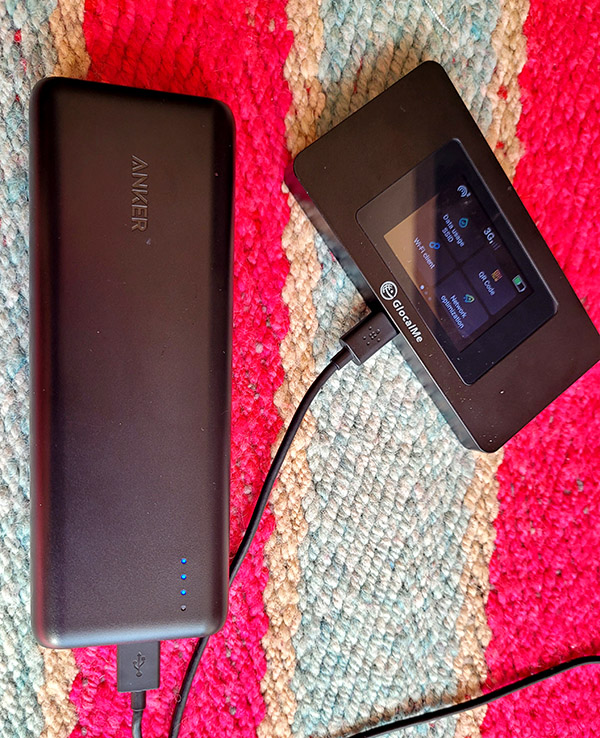 An Anker portable USB powerbank plugged into a GlocalMe portable wifi hotspot