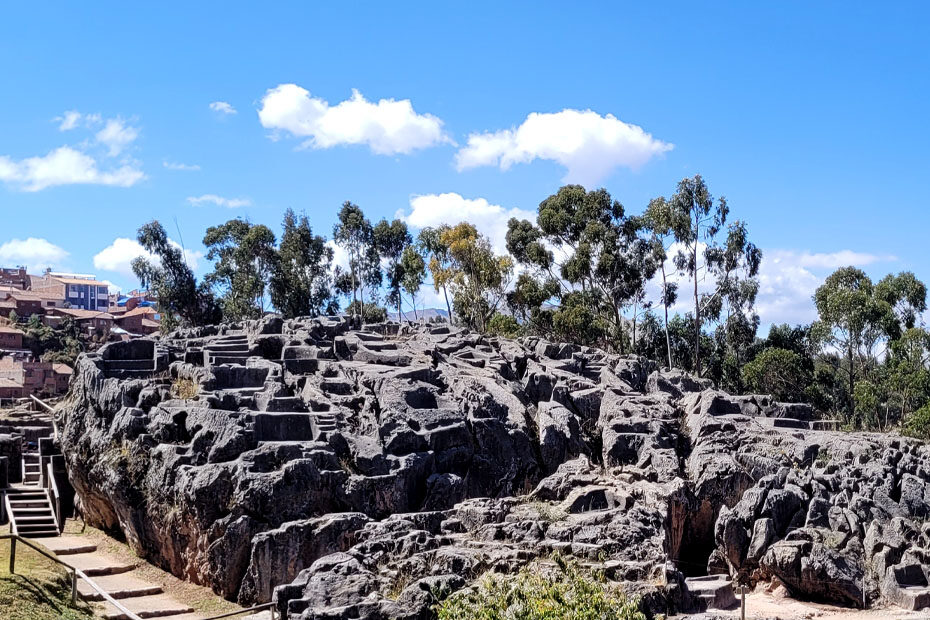 The archeological site of Qenqo, a mass of dark rock carved with many ledges and holes, one of the key Incan archeological sites around Cusco, Peru